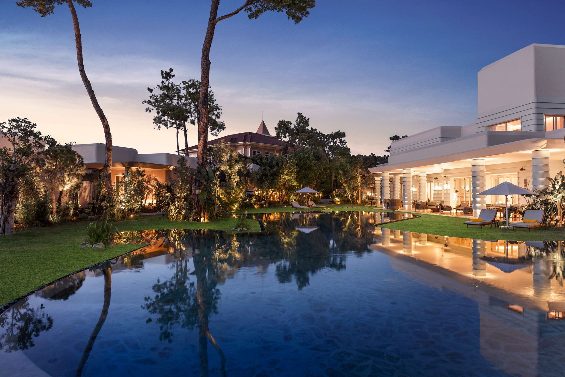 A large house with a large swimming pool in front of it