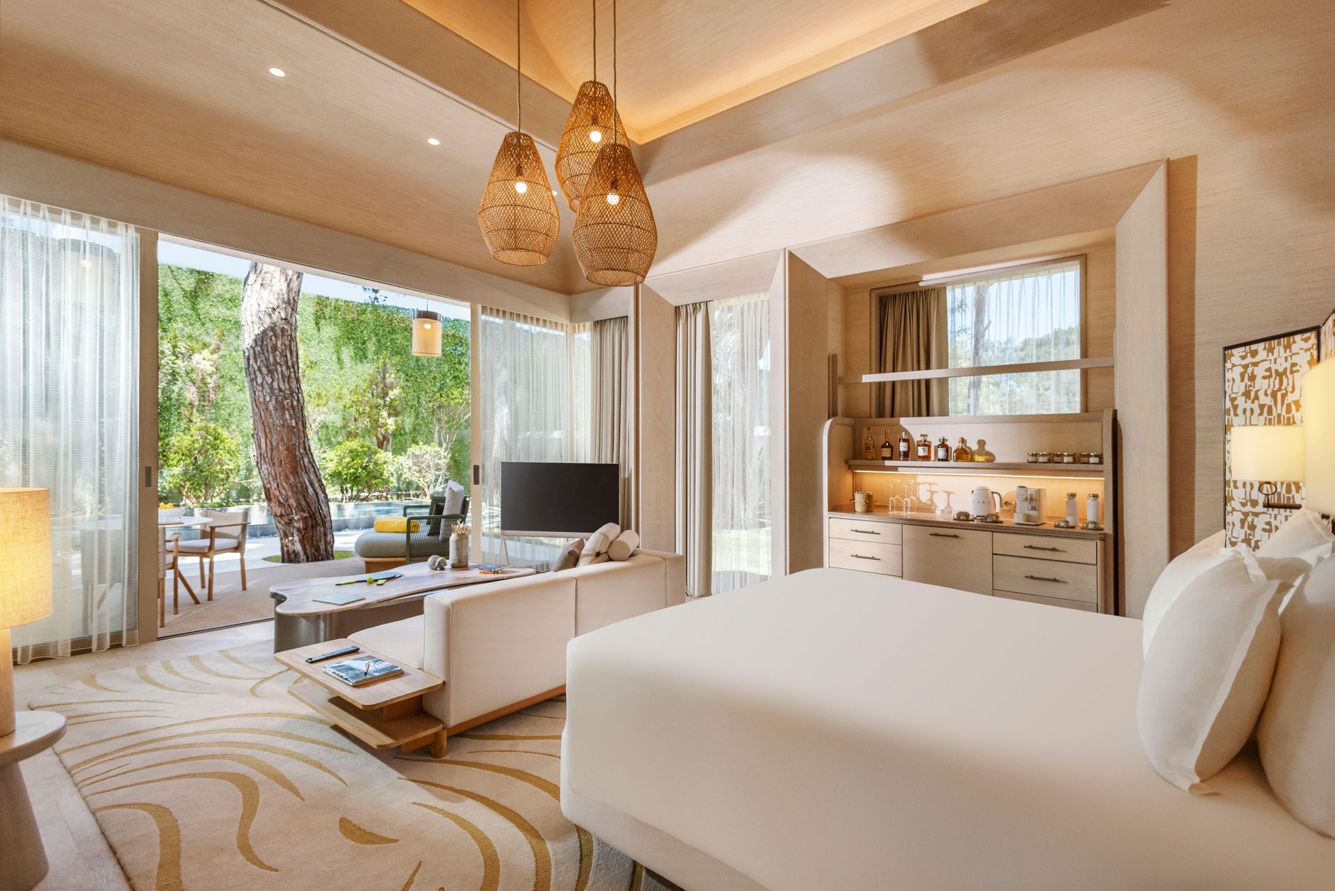 A hotel room with a king size bed , couch , and television.