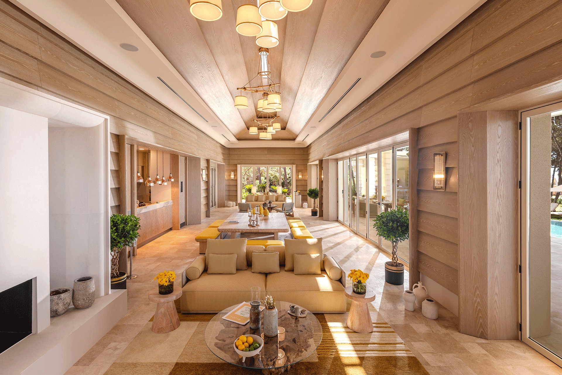 A living room with a couch , table , and chandelier.